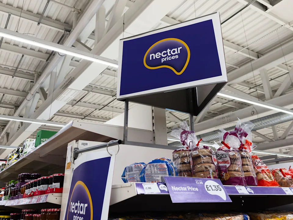 Salford, UK - September 25, 2025: Nectar Prices sign over bakery shelves in a UK Sainsbury's supermarket, with bagels and bread on display.