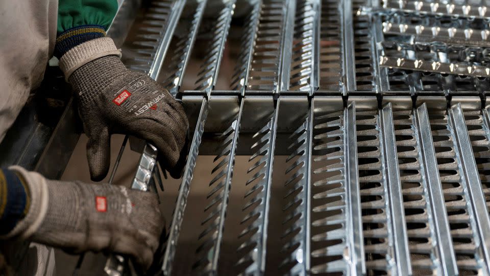 A worker handles components for a steel sieve at HCC, a company that uses parts to make combines, at the factory in Mendota, Illinois, on February 21, 2025. REUTERS/Vincent Alban - Vincent Alban/Reuters