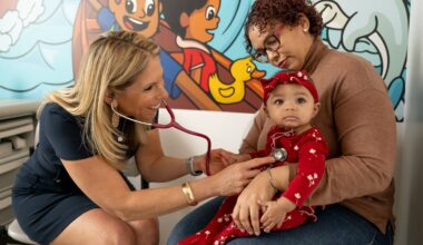 Dr. Robyn Riseberg with a patient and mother in Boston Community Pediatrics' South End offices.