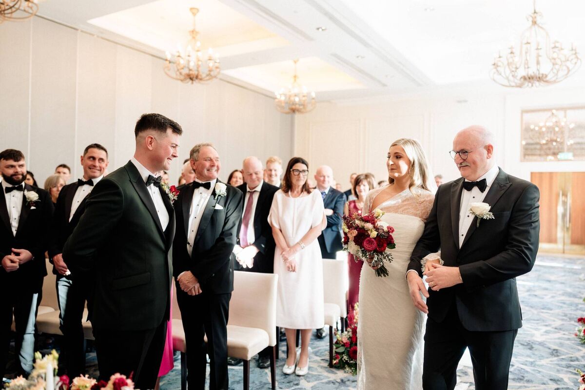 Bride Lisa Gray walks up the aisle on the arm of her dad Gerry Gray to bridegroom Cathal O'Riordan. Pictures: Sarah Kate Murphy, Sarah Kate Photography