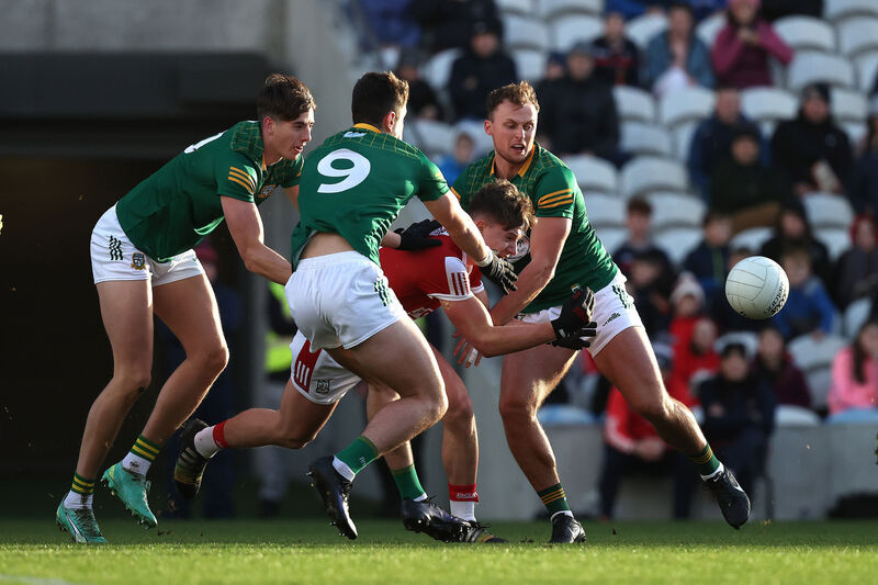 TRADITIONAL: Cork's Paul Walsh is tackled by Daithi McGowan, Jack Kinlough and Ronan Jones of Meath in the Teddy McCarthy tribute game in 2023. Picture: INPHO/Bryan Keane