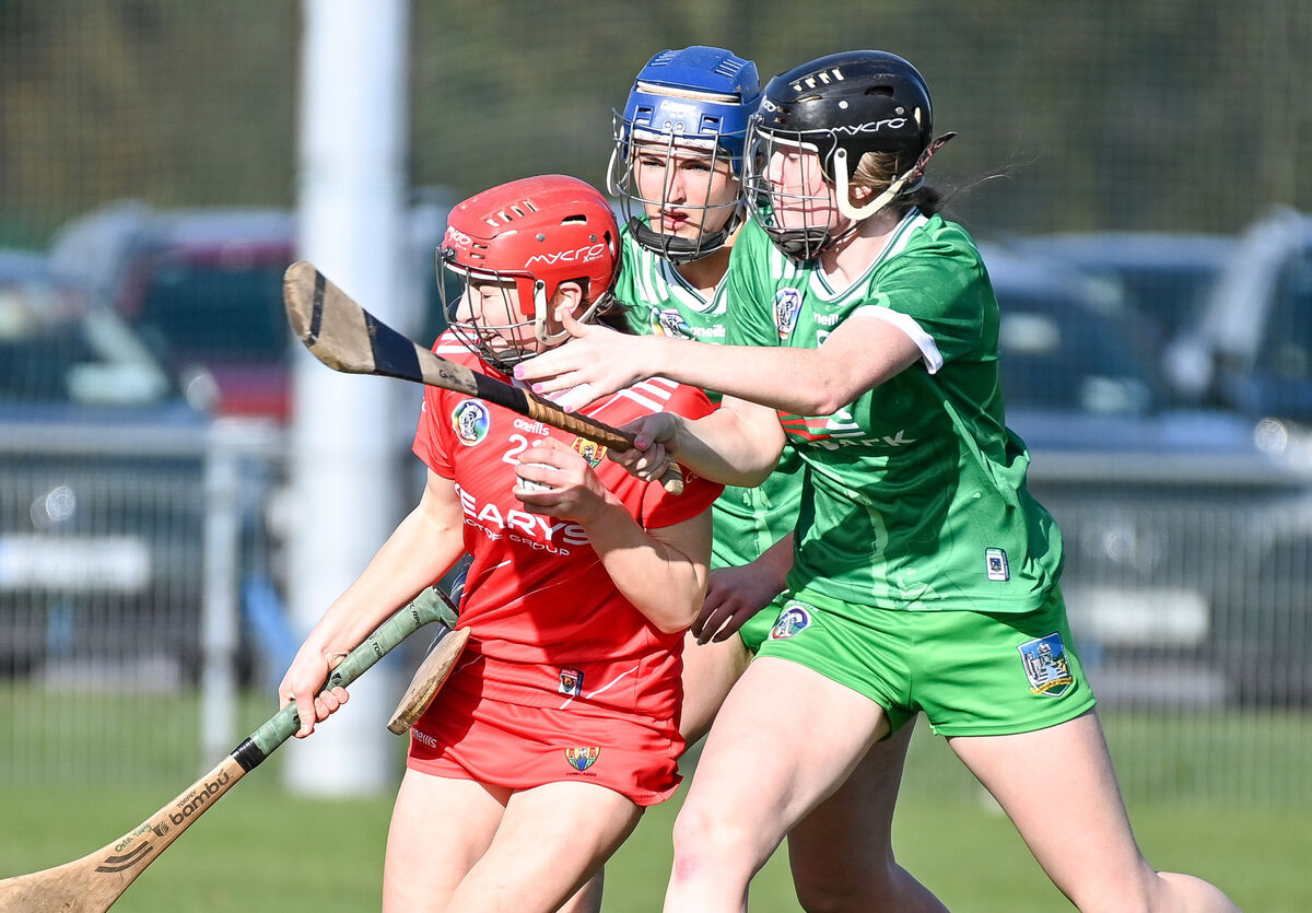  Cork's Orla Troy is tackled by Limerick's Caitlin Ryan during their Minor Camogie All-Ireland championship clash at Castle Road. 