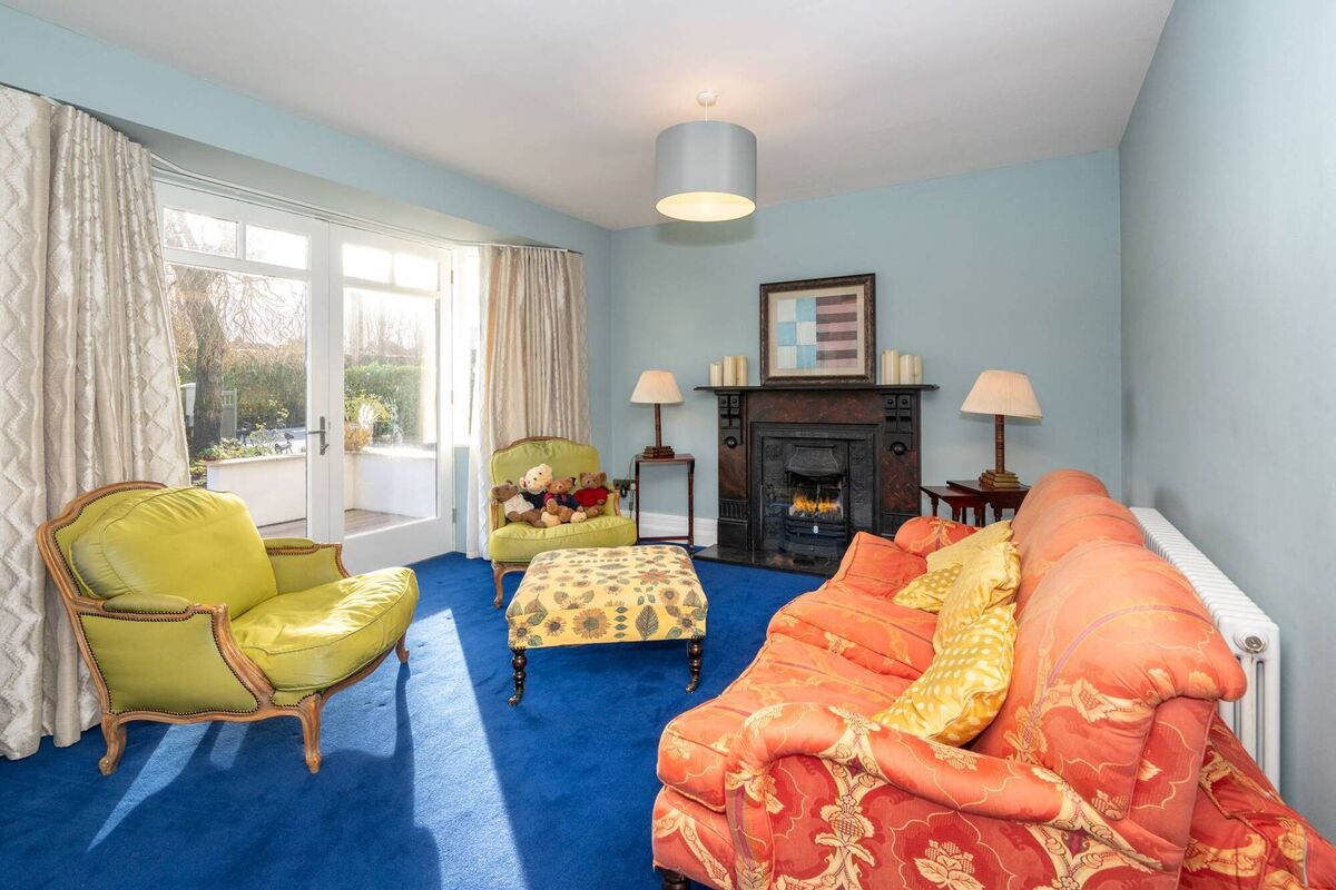 Graceful French doors open from the living room to a south facing front patio