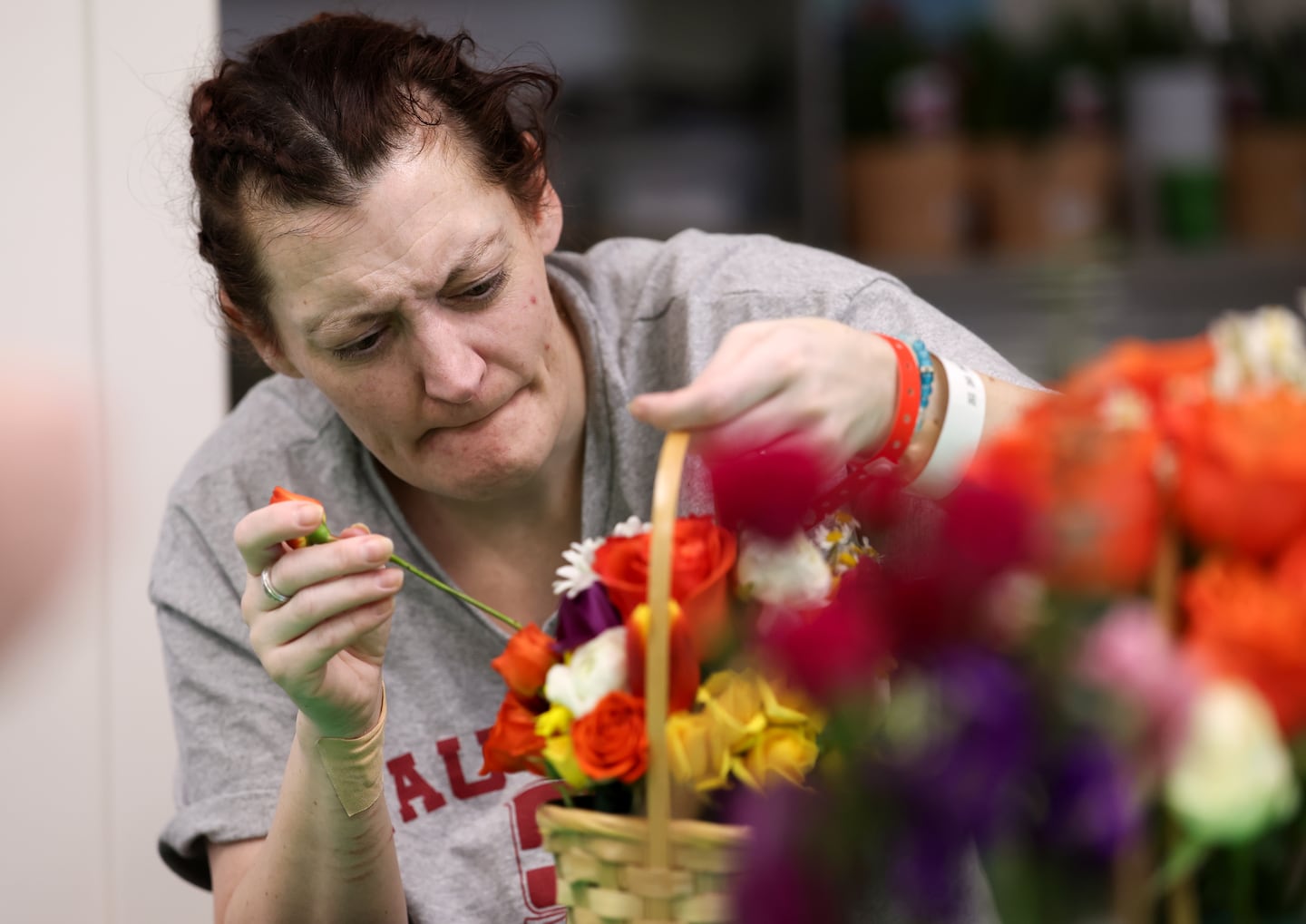 Jenni builds her bouquet of flowers at the Acton Garden Club Flower Day at Emerson Hospital.