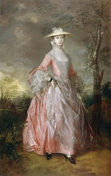 A woman in an 18th-century pink gown and wide-brimmed hat stands outdoors, surrounded by trees and a scenic landscape.