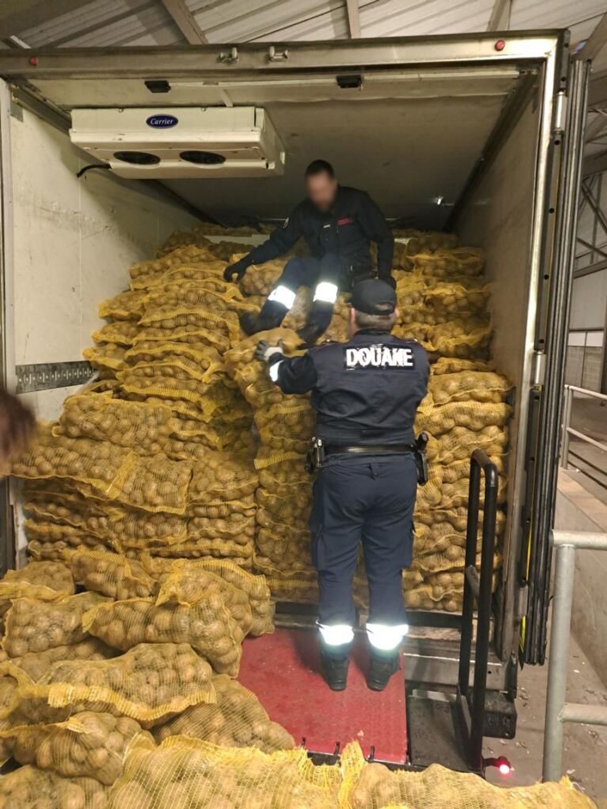 French Customs officials inspecting the lorry.