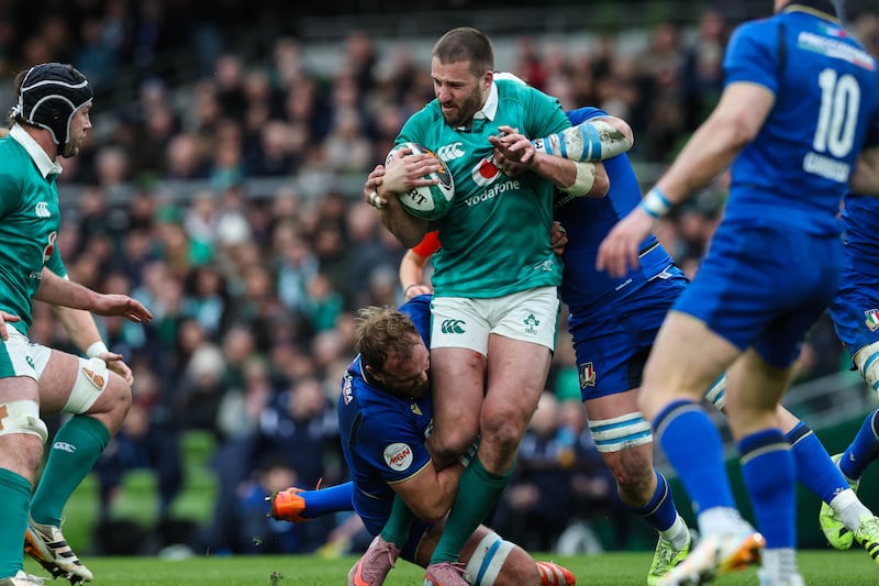Ireland's Stuart McCloskey is tackled by Italy's Niccolo Cannone. Photograph: Billy Stickland/Inpho
