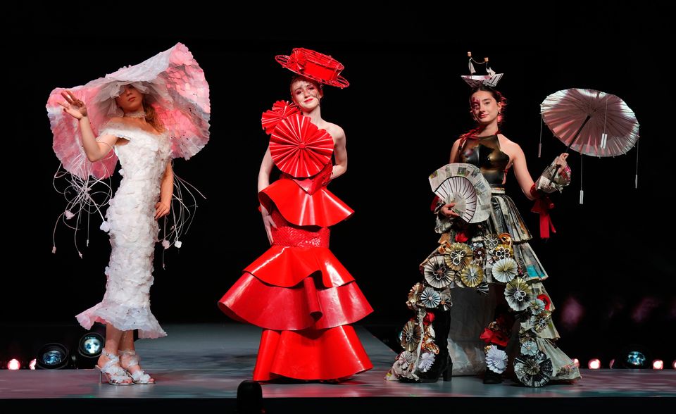 Emilija Milasiute wearing her design La La Lu Veil, made from plastic milk bottles, plastic packaging straps, and pearl beads, Isabel Ryder wearing her design Blazing Muse, which she created with Niamh Donohoe and Lilly Mangan out of recycled materials and Marie-Antoinette À La Rose, worn by Laura Peterfalvi of Lycée Professionnel Ferdinand Buisson, France, created from newspapers, transport tickets, and magazines during the Junk Kouture World Final at The Helix, Dublin. Niall Carson/PA Wire