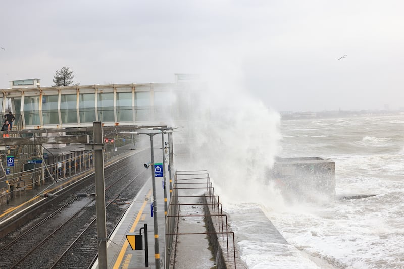 Waves crash over Blackrock dart station.