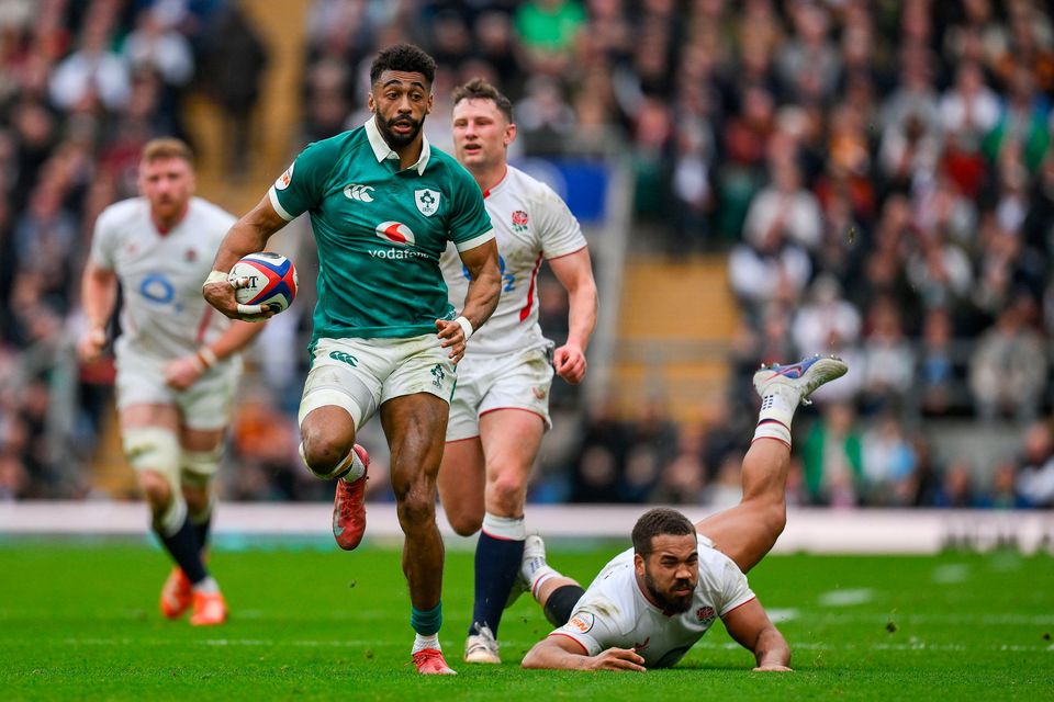 Robert Baloucoune beats the tackle of England's Ollie Lawrence before setting up Ireland's third try against England. Photo: Sportsfile