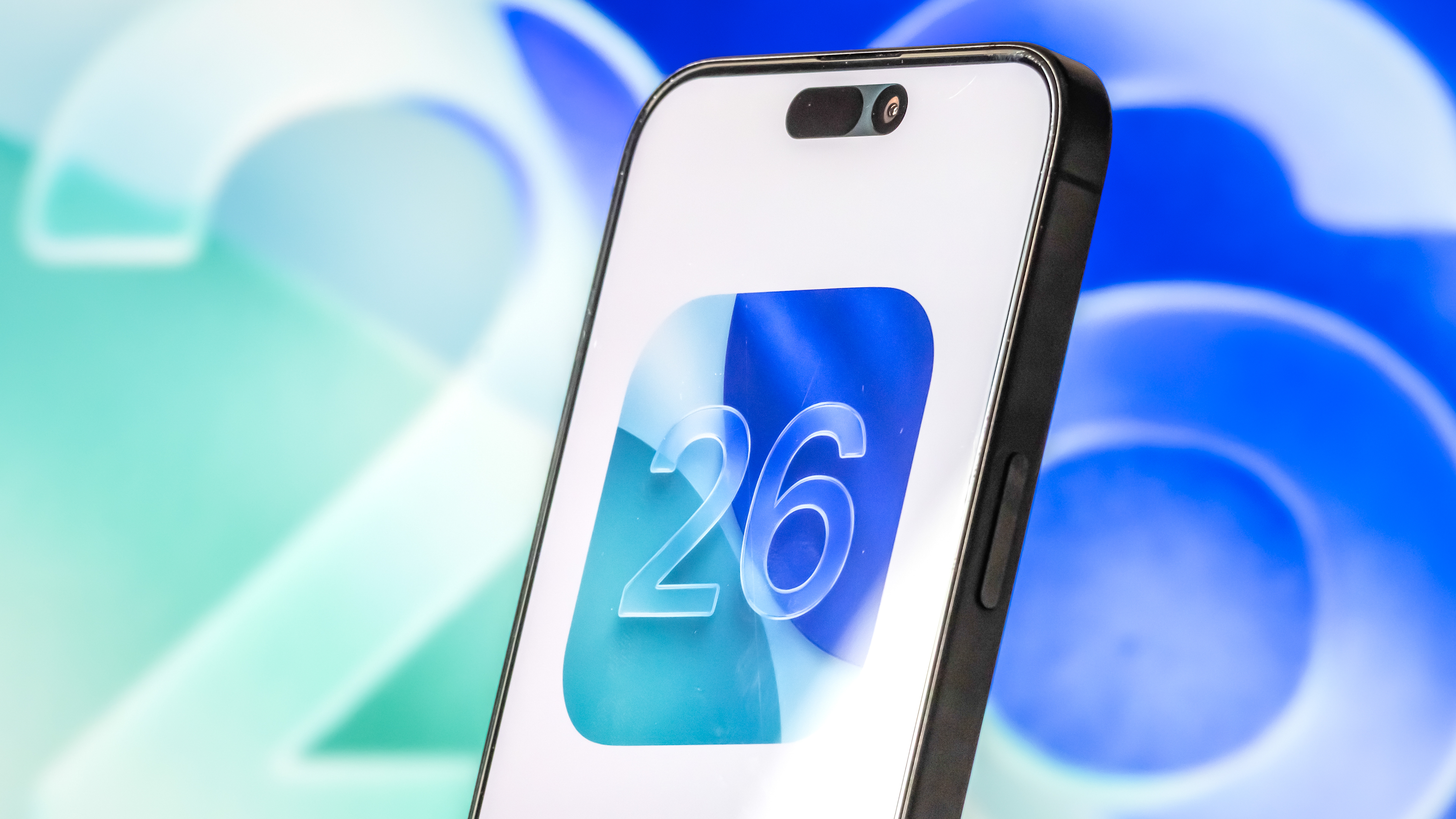 ios 26 logo on a phone with 26 in the background