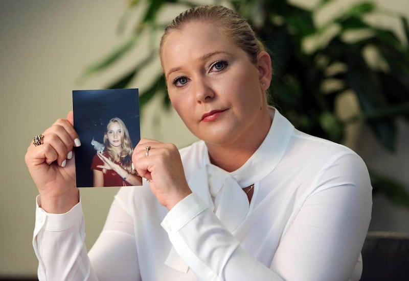 Virginia Giuffre, with a photo of herself as a teen, when she says she was abused by Jeffrey Epstein, Ghislaine Maxwell and Prince Andrew, among others. Photograph: Emily Michot via Getty Images