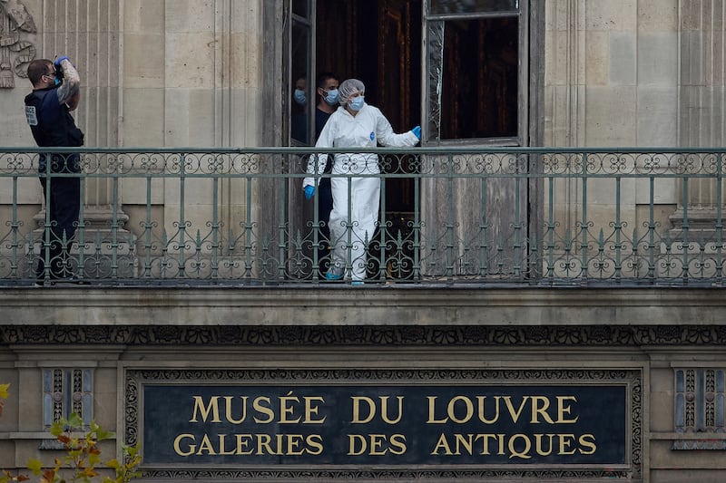 A forensics Officer examines the cut window and balcony of a gallery at the Louvre Museum which was the scene of a robbery last October. Photograph: Kiran Ridley/Getty Images