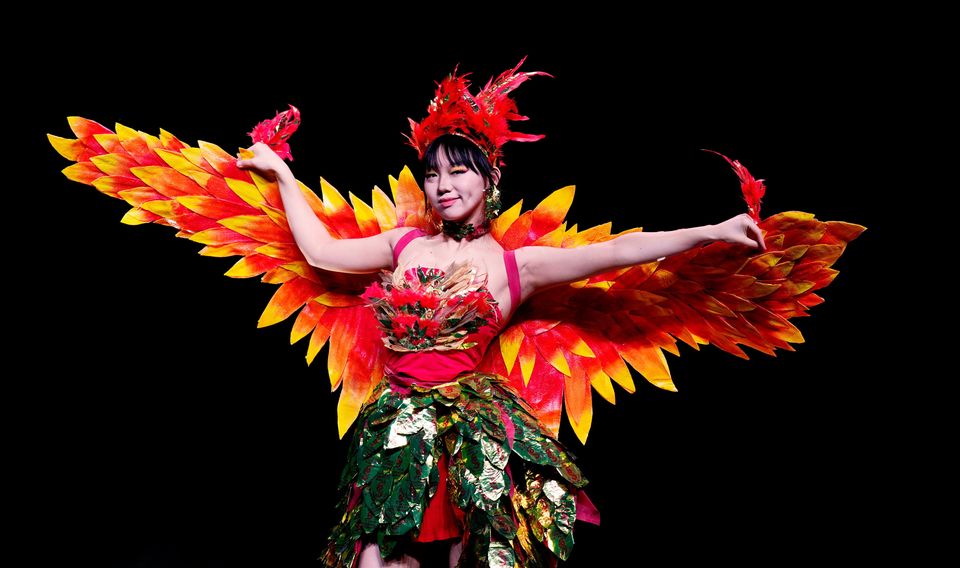 Hanyun Xu from Liceo Artistico Enzo Rossi in Italy, wears Golden Phoenix Fortune, created by Asia Rubini and Viviana Furgiuele and made from fortune cookie wrappers, old tablecloths, and packaging, during the Junk Kouture World Final at the Helix in Dublin. Niall Carson/PA Wire