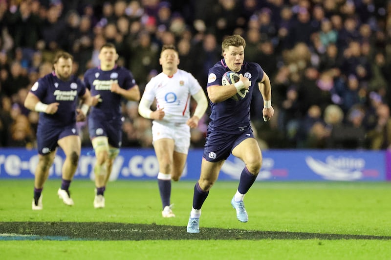 Scotland's Huw Jones (right) runs through to score a try. Photograph: Steve Welsh/PA
