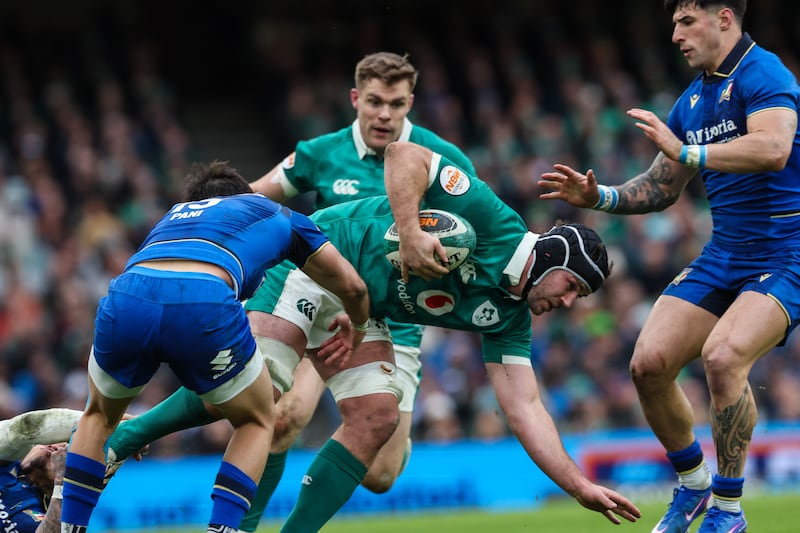 Ireland's Caelan Doris is tackled by Italy's Monty Ioane. Photograph: Billy Stickland/Inpho