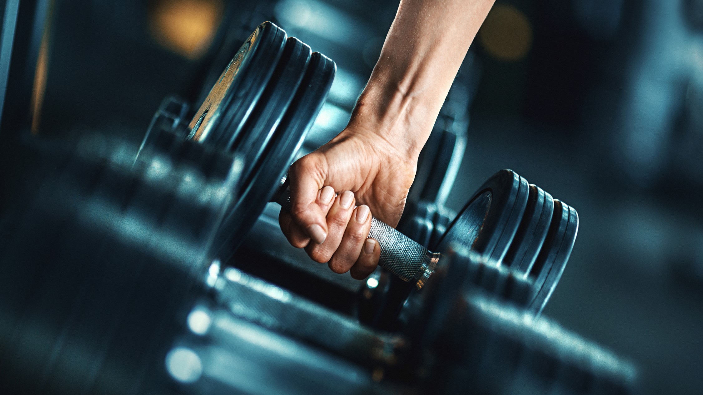 a woman lifting a heavy dumbbell