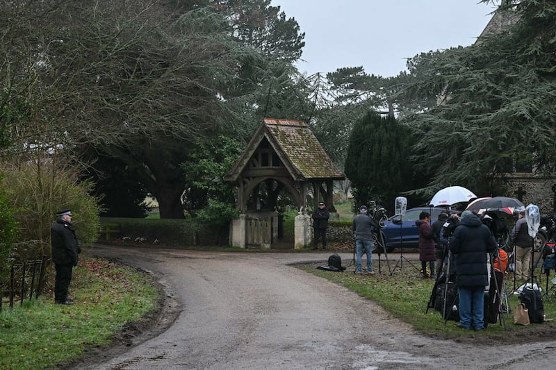 Police stand at an entrance to Wood Farm on the royal family's Sandringham Estate near members of the media in Norfolk, England, Thursday. Photograph: Justin Tallis/AFP via Getty