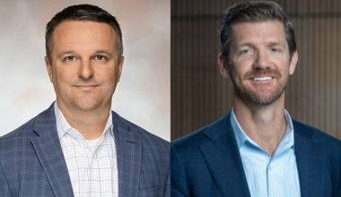 A photo showing Brian Jackson and Jonathan Schneider, each wearing suit jackets and button-down shirts