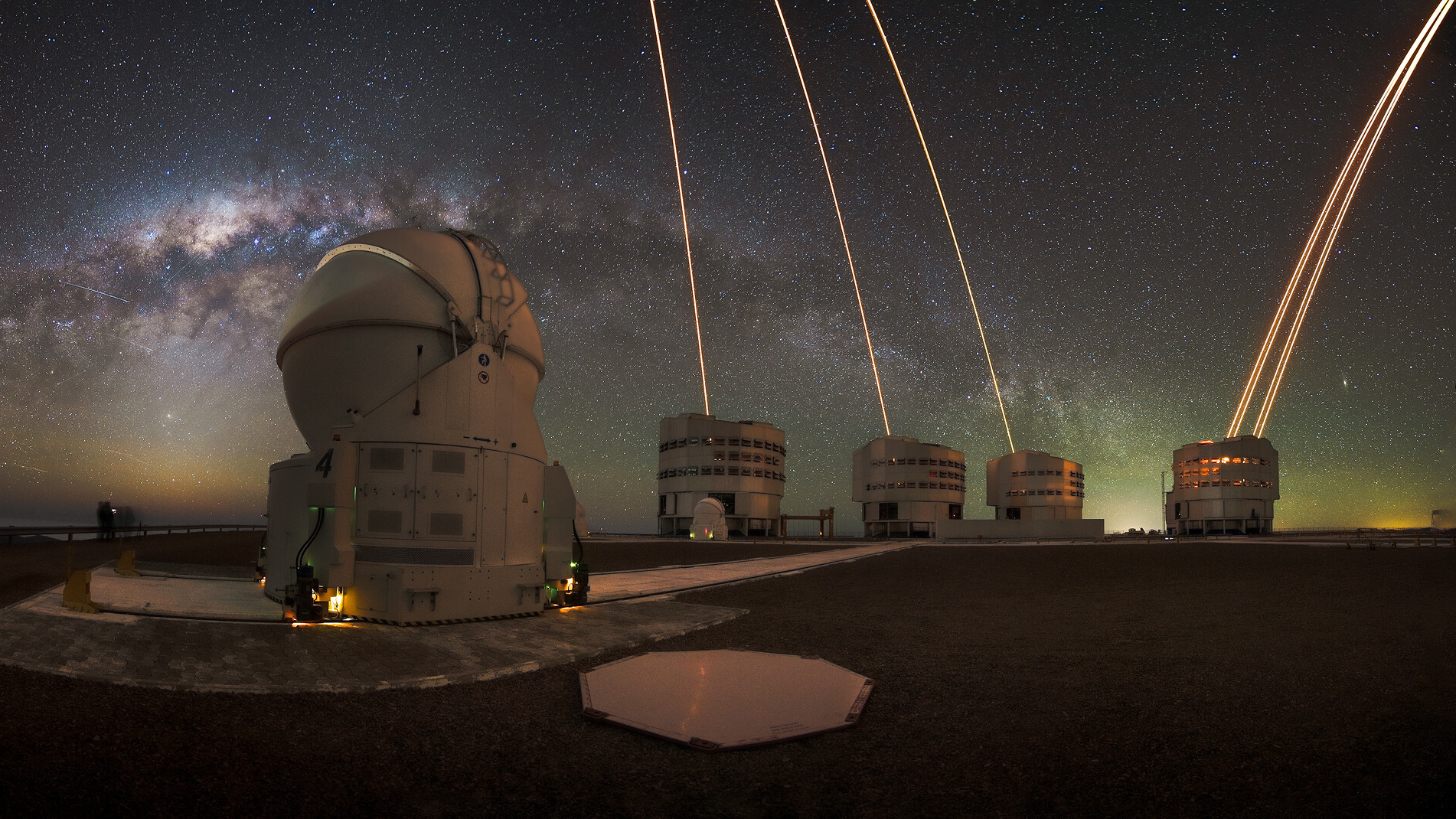 The Milky Way shines over the Very Large Telescope in Chile, as lasers arc skyward from the four background telescopes.