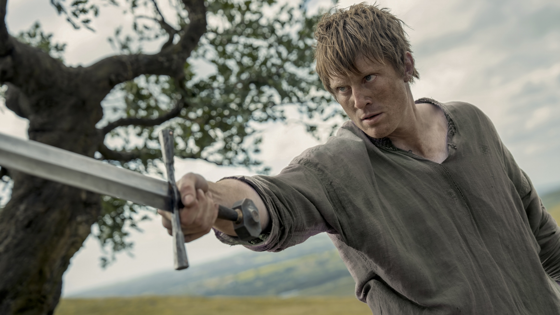 Dunk (Peter Claffey) wielding a sword in a scene from "A Knight of the Seven Kingdoms" episode 1