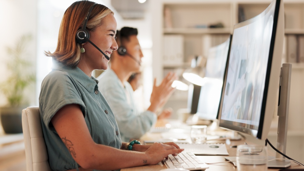 A women working on her laptop with headset.
