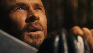 Thor with his hand resting on Stormbreaker looking up