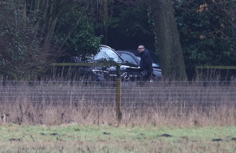 Men step out of an unmarked car at the home of Andrew Mountbatten-Windsor on Thursday. Photograph: Peter Nicholls/Getty Images