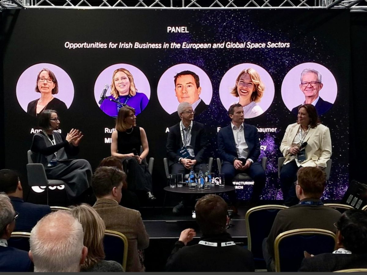 Five people sitting on a panel with their photos behind, three women, two men.