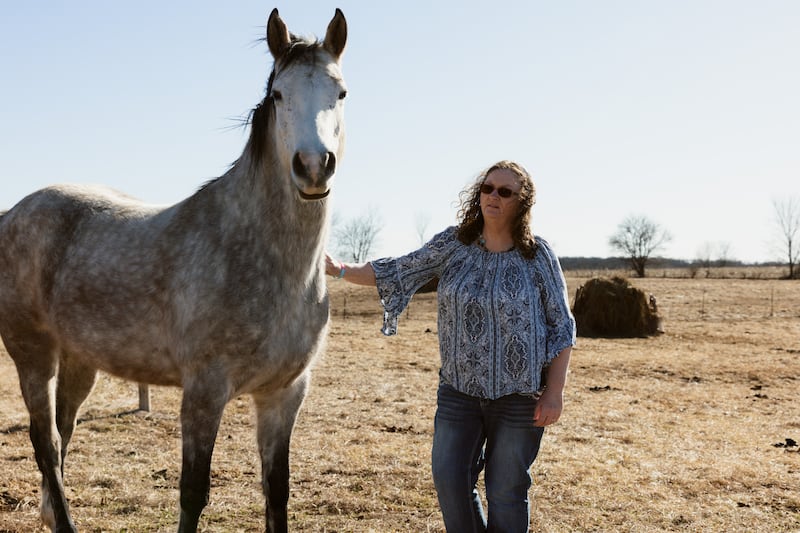 Donna Hughes Brown with her horses at a field behind their home in Bowling Green, Missouri. Photograph: Chase Castor