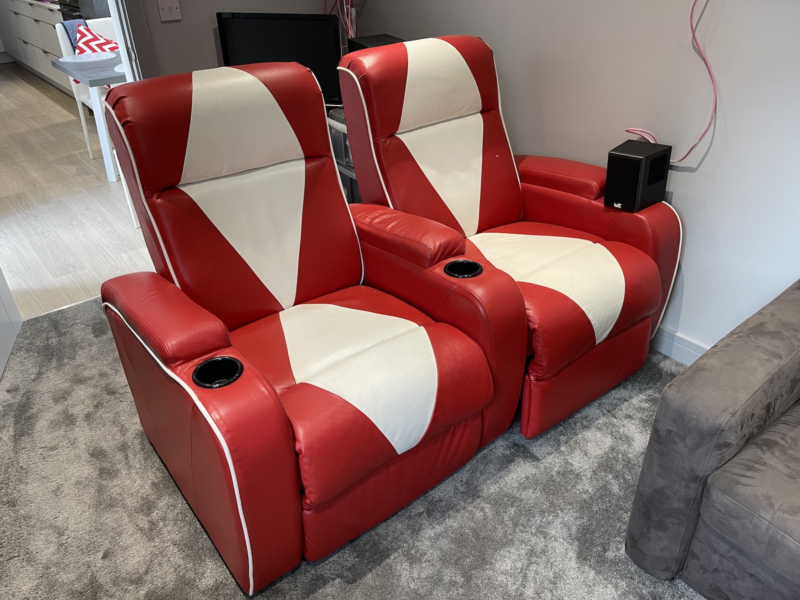 A photo of two bright red home cinema chairs