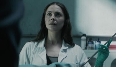 Willa Holland as Rebecca Owens in The Mortuary Assistant, holding a long needle