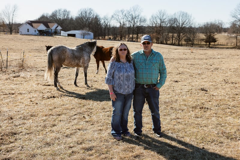 Donna Hughes Brown and her husband Jim Brown visit their horses at a field behind their home in Missouri. Photograph: Chase Castor