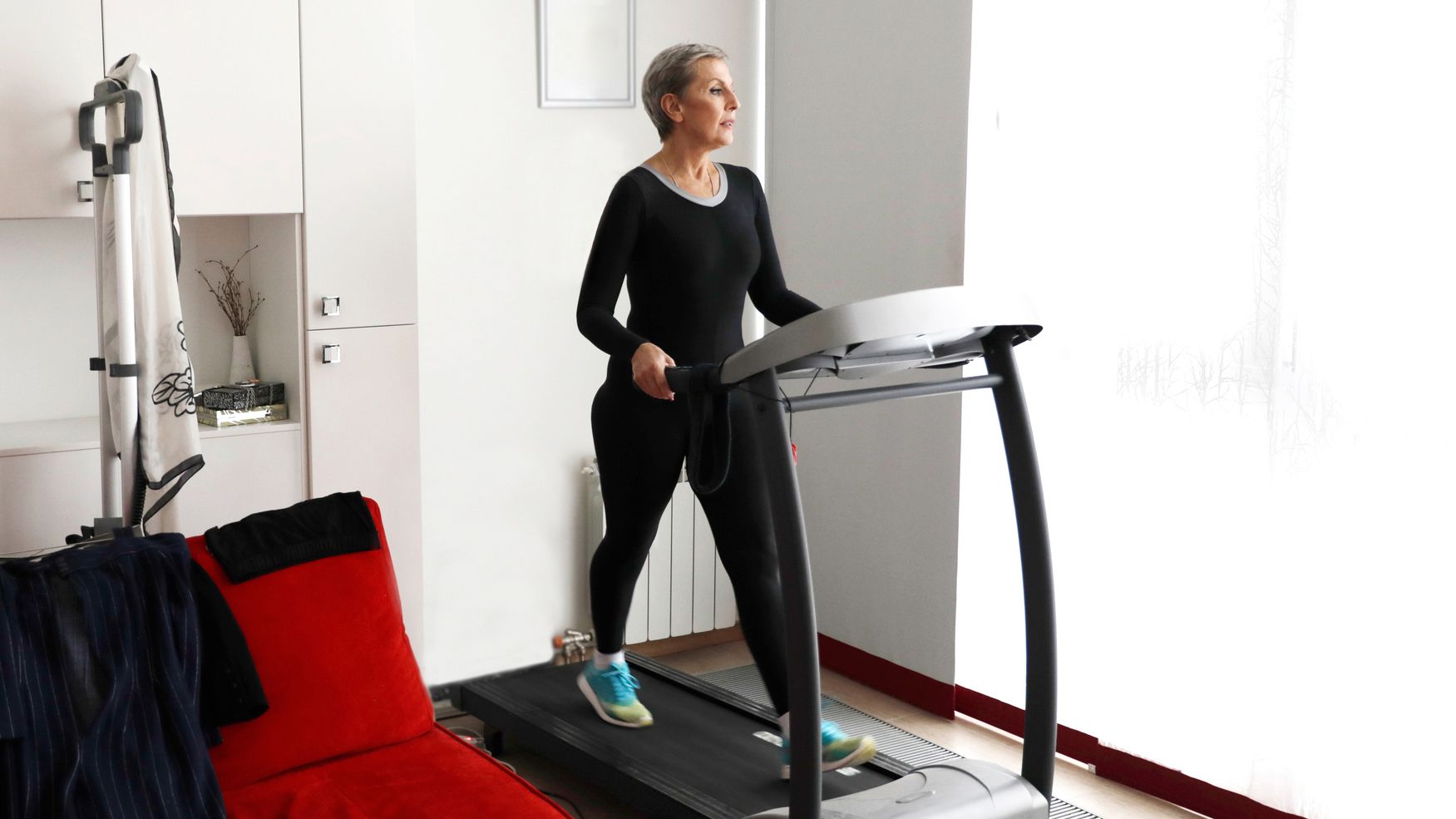 Woman walking on treadmill at home