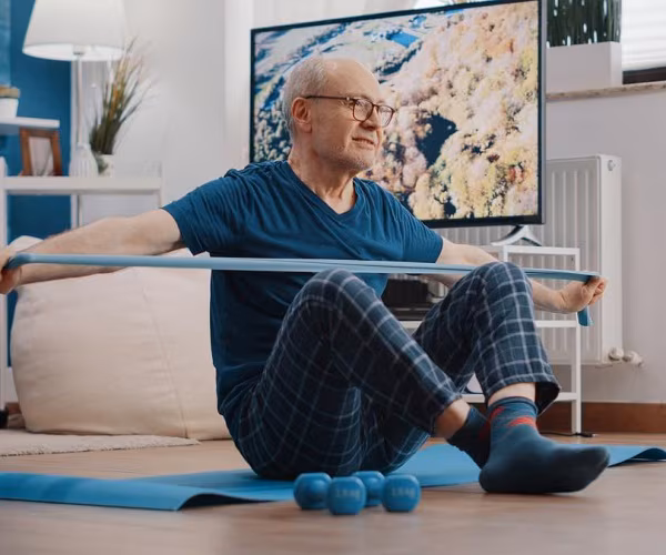 man doing physical therapy exercises at home