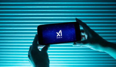 A person holds a telephone displaying the logo of Elon Musk s artificial intelligence grok in front of a background lit by a blue light.