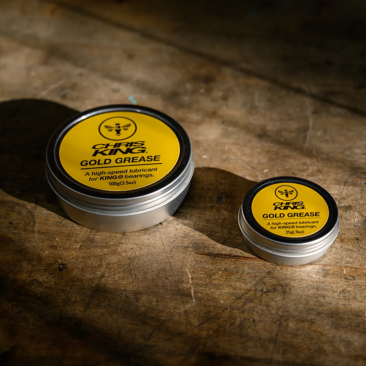 Two tins of Chris King Gold Grease.