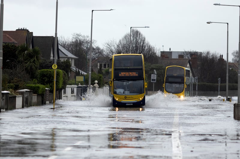 Buses make their way along the flooded Clontarf Road. Photograph: Chris Maddaloni