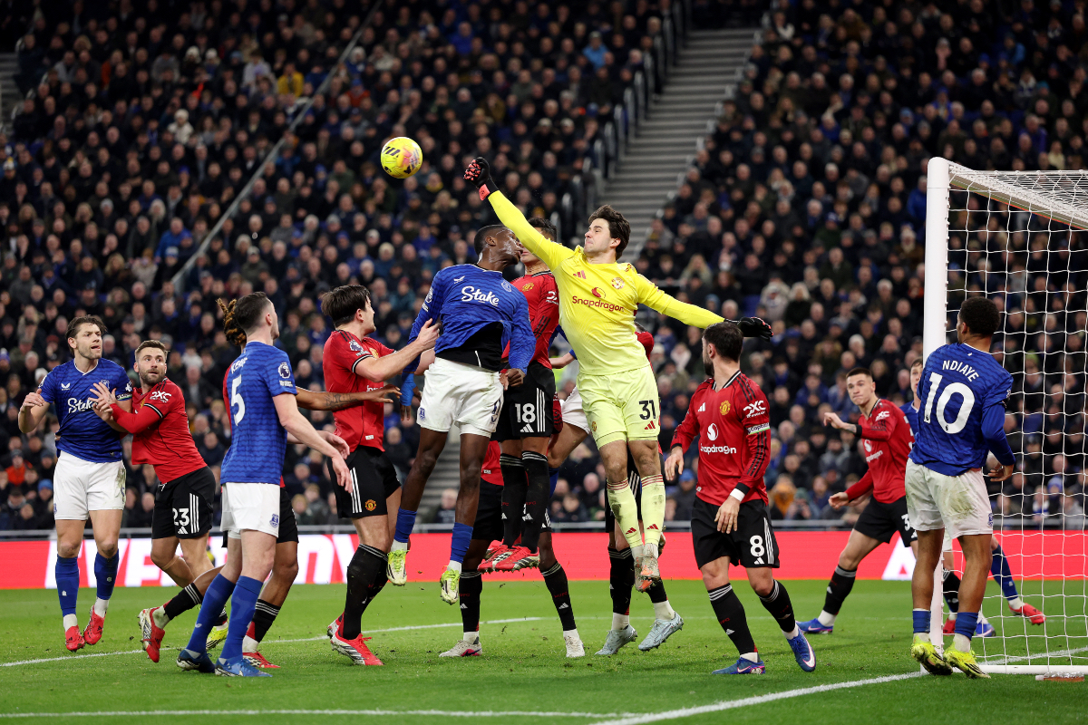 Senne Lammens leaps to punch away a corner while in action vs Everton