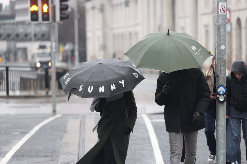 Braving the rain beside the Liffey in Dublin this week. Photograph: Enda O’Dowd