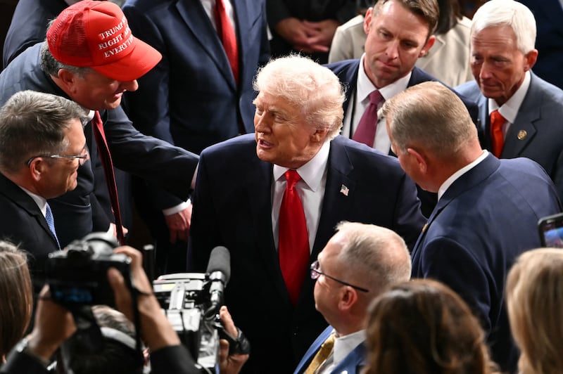 Donald Trump shakes hands with members of congress as he departs following his state of the union address. Photograph: Andrew Caballero-Reynolds/AFP via Getty Images