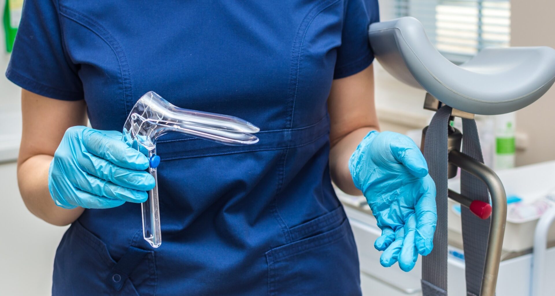Gynecologist holding a gynecological speculum with gloves