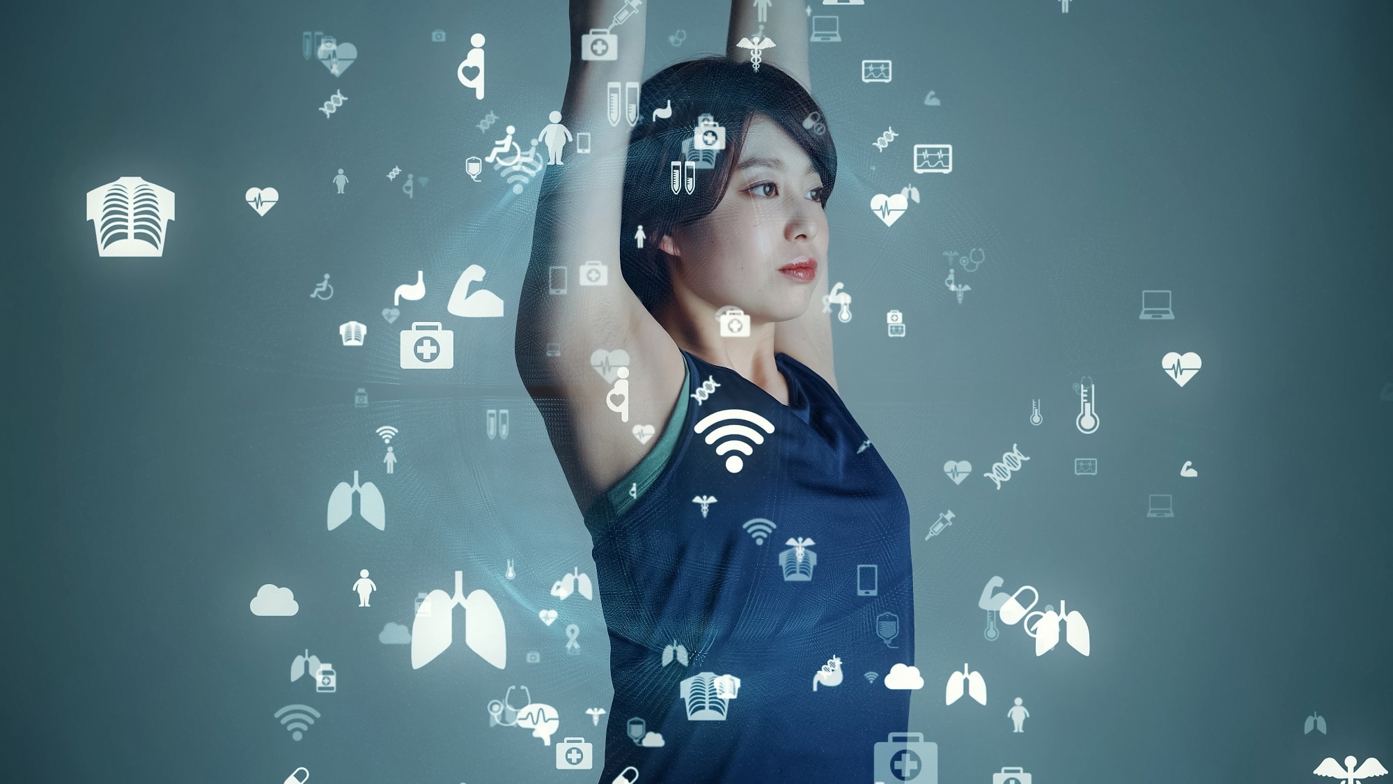 Woman raising her arms with digital health and wearable sensor icons overlaid, illustrating smart textiles and motion tracking technology.
