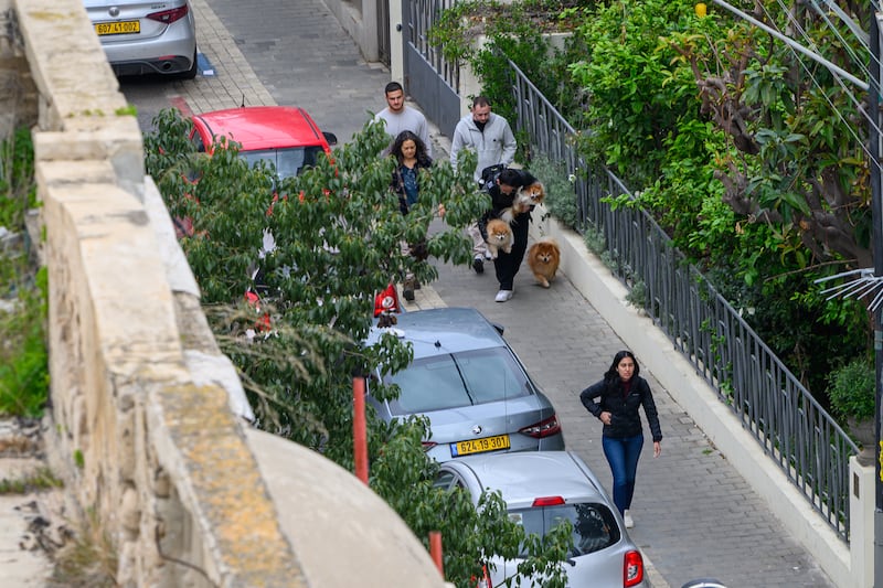  People run to bomb shelters as red alert sirens are sounded  in Tel Aviv, Israel. Photograph: Alexi J. Rosenfeld/Getty Images