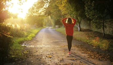Woman in an orange jumper walking through the woods