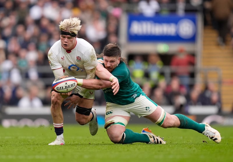 England's Henry Pollock is tackled by Joe McCarthy. Photograph: Andrew Matthews/PA 

