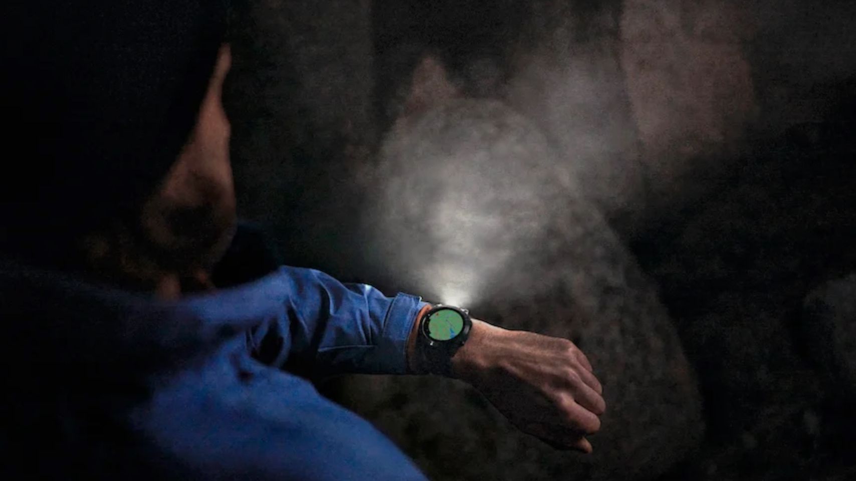A person with a smartwatch emitting an LED light beam