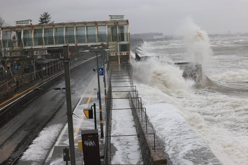 Waves crash over Blackrock dart station.