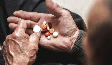Assorted tablets in hands of elderly man