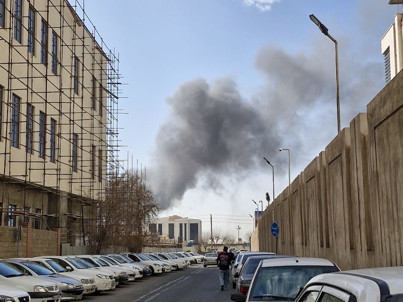 A plume of smoke rises over Tehran. Photograph: Ehsan / Middle East Images / AFP via Getty Images